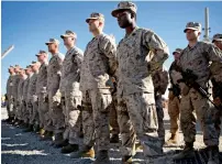  ?? AP file ?? US Marines stand guard during the change of command ceremony in Helmand province, Afghanista­n. —