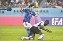  ?? Korea Times photo by Choi Won-suk ?? Japan’s Takumi Minamino, left, and Germany’s Antonio Rudiger compete for the ball during the 2022 Qatar World Cup Group E match at Khalifa Internatio­nal Stadium in Doha, Wednesday.