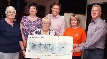  ??  ?? In The Crosses lounge, Kilmuckrid­ge, fundraisin­g trio Catherine O’ Connor, Vera O’Sullivan, and Anne Hammell present a cheque for over €4,000 to Friends of Wexford Hospital chairman, Ciaran Sheridan, Caroline Kennedy and Niall Reck.