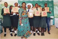  ?? ?? Securico managing director, Dr Divine Simbi Ndhlukula, poses with pupils at the official launch of Mbuya Mary Simbi computer lab and library in Gutu at the weekend.