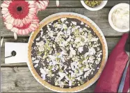  ?? ANDREA POTISCHMAN — SIMMER + SAUCE ?? This gluten-free Coconut-Chocolate Almond Tart uses almond flour, making it a perfect option for dessert for Passover or any occasion.