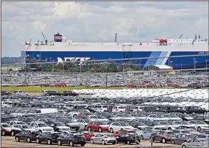  ?? Bloomberg News/MARK ELIAS ?? New Kia vehicles are unloaded at the Georgia Ports Authority in Brunswick, Ga., in this file photo. The U.S. trade deficit fell to $43.4 billion in October and is running 4.8 percent below the same period in 2013.