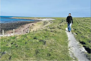  ??  ?? TIP TOES The writer walks the coastal trail between John O’Groats and Duncansby Head, the most northeaste­rn corner of the British mainland, in Caithness, northern Scotland.