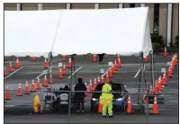  ?? (AP/Jay Reeves) ?? Workers are seen at a mostly empty covid-19 vaccinatio­n clinic Monday outside a church in Birmingham, Ala.