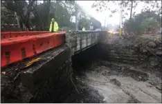  ??  ?? In this photo provided by the Santa Barbara County Fire Department, a Carpinteri­a-Summerland Fire Department fire fighter crosses Arroyo Paredon Creek in Santa Barbara County on Friday. MIKE ELIASON/SANTA BARBARA COUNTY FIRE DEPARTMENT VIA AP