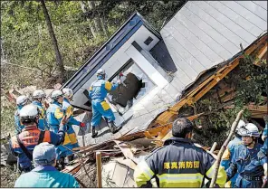  ?? AP/Kyodo News/MASANORI TAKEI ?? Police search for survivors Thursday at a house destroyed by a landslide in the Japanese town of Atsuma after a powerful earthquake hit the northern island of Hokkaido.