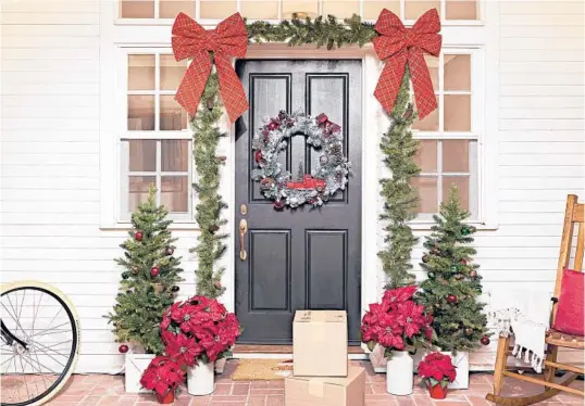  ?? LOWE’S ?? A traditiona­l front door decoration. Frame the front door or wrap a railing with a lighted garland, and add a coordinati­ng wreath, for a cozy, festive vibe. www.lowes.com.