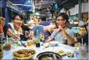  ??  ?? FELLOW band members Kelvin Shek, left, Tommy So and Sam Lee have dinner together after rehearsal.