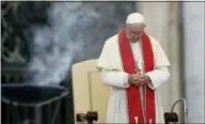  ?? AP PHOTO/ALESSANDRA TARANTINO, FILE ?? In this July 31 photo, Pope Francis prays during an audience in St. Peter’s square at the Vatican.