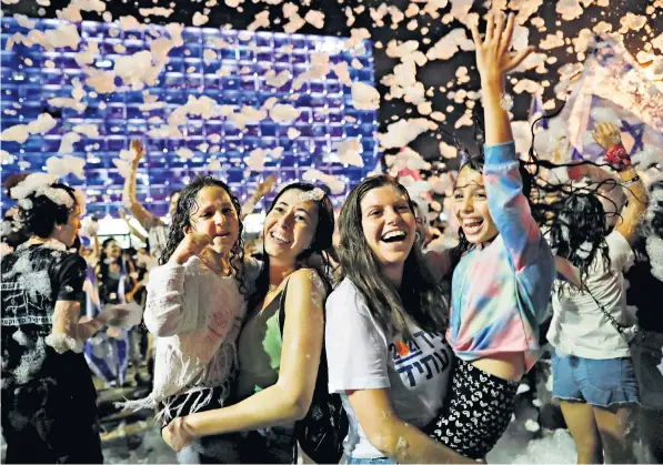  ??  ?? Celebratio­ns in Rabin Square, Tel Aviv, last night after Israel’s parliament voted in a new coalition ending Benjamin Netanyahu’s 12-year hold on power