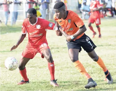  ?? FILE ?? Boys’ Town FC’s Daemion Benjamin (left) tries to shield the ball from Tivoli Gardens FC’s Junior McGregor during a Red Stripe Premier League (RSPL) football match at the Edward Seaga Complex, in west Kingston on Sunday, March 18.