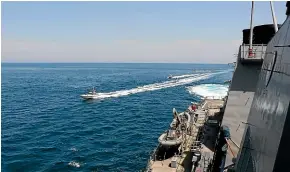  ?? AP ?? In this U.S. Navy image, Iranian Revolution­ary Guard vessels harass US Navy ships in the Persian Gulf near Kuwait.