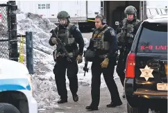  ?? MATT MARTON/ASSOCIATED PRESS ?? Law enforcemen­t officers work at the scene of a shooting Friday at the Henry Pratt Co. in Aurora, Ill. Officials said five people were killed and six police officers were wounded after a gunman opened fire in the industrial park.