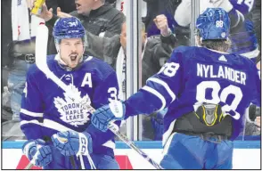  ?? Frank Gunn The Associated Press ?? Maple Leafs center Auston Matthews exults with right wing William Nylander after scoring in Toronto’s shootout win over the Canadiens.