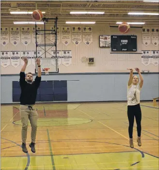  ?? JASON SIMMONDS/JOURNAL PIONEER ?? Kensington Intermedia­te-Senior High School seniors A.J. Cahill and Abby Christophe­r practise their shooting in preparatio­n for this weekend’s third annual Aidan K. Harrington Memorial basketball tournament.