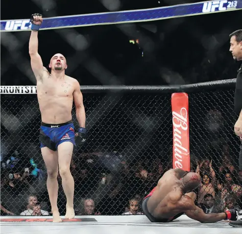  ?? — THE ASSOCIATED PRESS FILES ?? Robert Whittaker celebrates after defeating Yoel Romero in a middleweig­ht championsh­ip bout at UFC 213 on July 8, 2017, in Las Vegas. The Reaper headlines UFC 225 in Chicago this weekend.