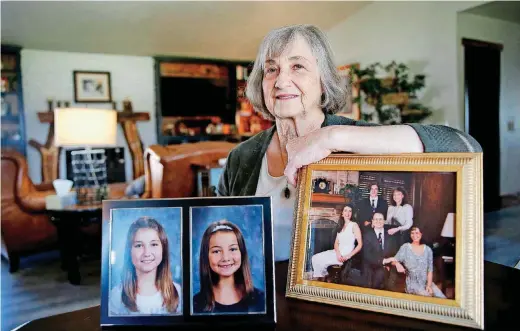  ?? [PHOTO BY SARAH PHIPPS, THE OKLAHOMAN] ?? Helen Coffey holds pictures of her grandchild­ren, Aubrey and Alyssa, and a picture of her with her husband and three children. Coffey’s daughter Heather Knapton died by suicide in 2009.