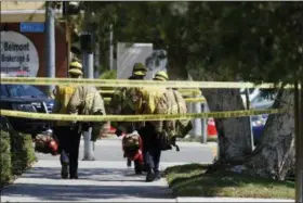  ?? JAE C. HONG — THE ASSOCIATED PRESS ?? Long Beach firefighte­rs walk along a street near a retirement home where at least one firefighte­r was killed in Long Beach on Monday. A resident of the retirement home in Southern California opened fire on firefighte­rs responding to a report of an...