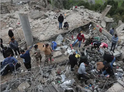  ?? Picture: Mohammed Zaatari/ap ?? People search for victims in the rubble of a paramedic centre that was destroyed by an Israeli airstrike in south Lebanon