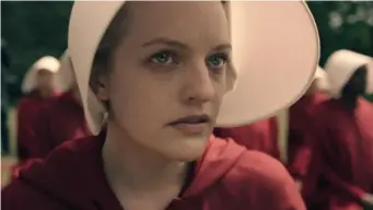  ??  ?? Moss plays Offred in 'The Handmaid's Tale' who is shipped off to be trained as a breeder to help infertile couples