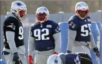  ?? BILL SIKES, THE ASSOCIATED PRESS ?? New England Patriots linebacker James Harrison, centre, stands between defenders Deatrich Wise, left, and Eric Lee, right, at practice Wednesday.