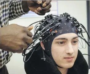  ?? JEFF MCINTOSH/THE CANADIAN PRESS ?? A device developed at the University of Calgary can measure the colour of blood in the brain, which can help determine the extent of injury following a concussion.