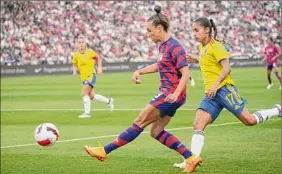  ?? David Zalubowski / Associated Press ?? U.S. forward Mallory Pugh, center, drives past Colombia defender Carolina Arias in the first half on Saturday. All the scoring came in the second half.