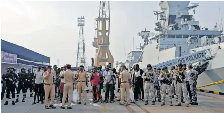  ?? REUTERS ?? INDIAN soldiers stand guard next to the captured Somali pirates after they were delivered for prosecutio­n by the Indian Navy, at the Naval Dockyard in Mumbai, India, yesterday.