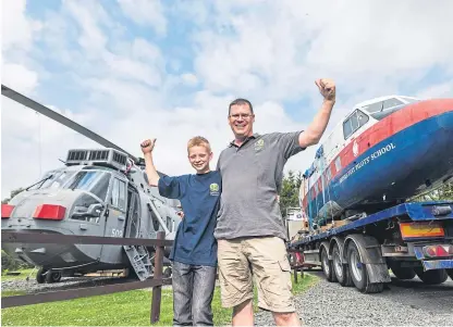  ?? Picture: PA. ?? Martyn Steedman and his son Harry, 11, are pictured with the recently-arrived Twin Pioneer alongside the Sea King helicopter which the farmer converted two years ago.