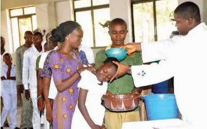  ??  ?? A cross-section of Catholic Faithful during their baptism at the Sacred Heart Parish, Gwagwalada in Abuja on Saturday