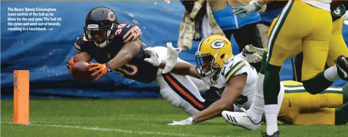  ?? | AP ?? The Bears’ Benny Cunningham loses control of the ball as he dives for the end zone. The ball hit the pylon and went out of bounds, resulting in a touchback.