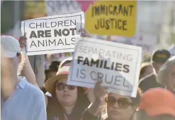 ?? — AFP ?? Critics of US government policy which separates children from their parents when they cross the border illegally from Mexico, protest during a ‘Families Belong Together March’, in downtown Los Angeles, California.