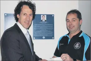  ??  ?? ACHIEVEMEN­T: Victoria Police Blue Ribbon Foundation Ararat branch member Dean Pinniger, right, hands over the branch’s final commitment to the Jason Bond Perioperat­ive Unit to East Grampians Health Service chief executive Nick Bush.