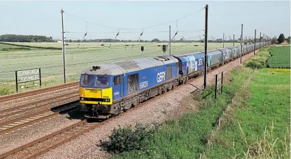  ?? RICHARD LILLIE ?? GB Railfreigh­t’s No. 60026 passes Overton, north of York, on June 24 with a loaded biomass train from Tyne Dock to Drax power station.