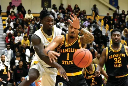  ?? (Pine Bluff Commercial/I.C. Murrell) ?? Ismael Plet of UAPB and Cameron Christon of Grambling State battle for a loose ball in the first half Monday at H.O. Clemmons Arena.