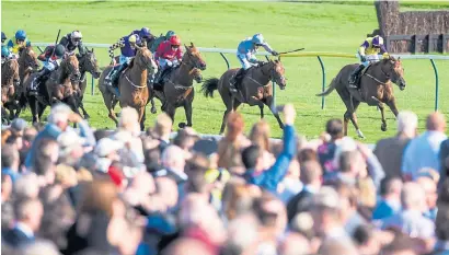  ??  ?? Tom Eaves steers Brando, right, to victory in the William Hill Ayr Gold Cup