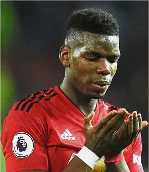  ?? — AFP ?? Grateful: Manchester United midfielder Paul Pogba saying a prayer after the final whistle during the Premier League match against Huddersfie­ld at Old Trafford on Wednesday.