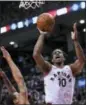  ?? NATHAN DENETTE — THE CANADIAN PRESS VIA AP ?? In this May 1, 2018, file photo, Toronto Raptors guard DeMar DeRozan (10) scores over Cleveland Cavaliers guard George Hill during the first half of Game 1 of an NBA basketball playoffs Eastern Conference semifinal, in Toronto.