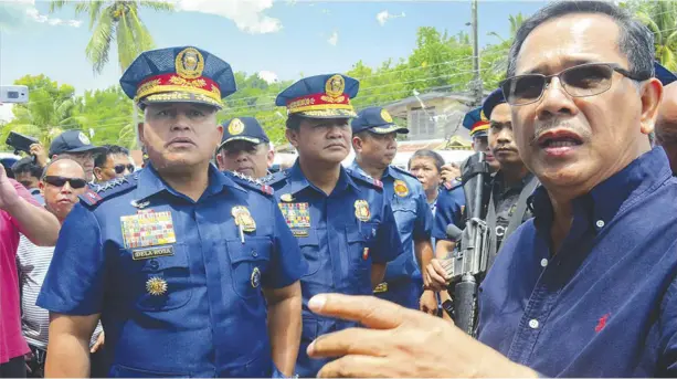  ?? IAN PAUL CORDERO/PN ?? GENERAL INSPECTION. A disappoint­ed General Ronald “Bato” Dela Rosa (left) visits the municipali­ty of Maasin, Iloilo five days after rebels raided the town’s police station. Policemen did not put up a fight, he bewails. Mayor Mariano Malones (right) is...