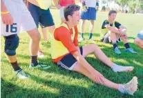  ?? GREG SORBER/JOURNAL ?? Twins Alex, left, and Charles Touche listen to their coach during a soccer practice at Albuquerqu­e Academy in 2015.