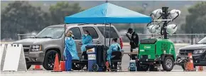  ?? William Luther / Staff file photo ?? Officials work in March at a drive-thru coronaviru­s testing location at the Freeman Coliseum. Free testing still is being provided there, but appointmen­ts are required.