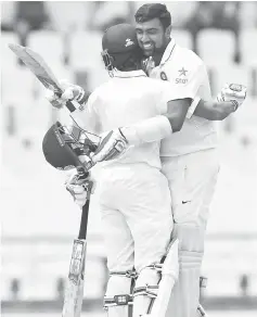  ??  ?? Wriddhiman Saha (left) and Ravichandr­an Ashwin hug in celebratio­n of both of their centuries during day 2 of the 3rd Test between West Indies and India at Darren Sammy National Cricket Stadium Gros Islet, St. Lucia in this Aug 10 file photo. — AFP photo