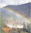  ?? TREVOR HUGHES, USA TODAY ?? A rainbow arches above the Feather River where it flows under power lines beneath the Oroville Dam.