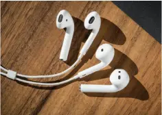  ??  ?? The wireless Airpods resemble the Earpods, but the Airpods have a heftier, more substantia­l design that stays put in my ears.