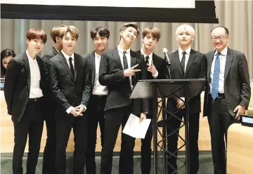  ??  ?? BTS members with World Bank President Jim Yong Kim (right).