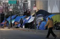  ?? FRANCINE ORR/LOS ANGELES TIMES FILE PHOTOGRAPH ?? The streets are lined with tents near East 5th Street and South San Pedro Street in the skid row area of Los Angeles on Feb. 15, 2018.