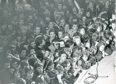  ??  ?? Fans swarm around the stage at the Caird Hall in 1980 eager to see punk rockers The Clash in concert.