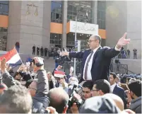  ?? (Mohamed Abd El Ghany/Reuters) ?? EGYPTIAN LAWYER Khaled Ali cheers in front of the State Council courthouse in Cairo in January after the administra­tive court’s ruling.