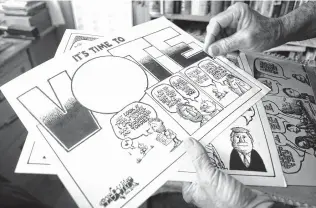  ?? Jessica Lutz / Contributo­r ?? Gary Oliver shows a cartoon about voting fatigue, one of many in his library spanning decades of work. Oliver, of Marfa, has been published weekly in the Big Bend Sentinel since 1983.