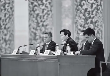  ??  ?? Tuo Zhen (center), spokesman for the 19th National Congress of the Communist Party of China, speaks at a press conference on Tuesday at the Great Hall of the People in Beijing.